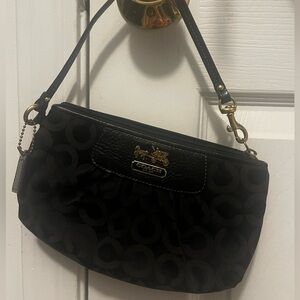 Black Coach wristlet with purple interior